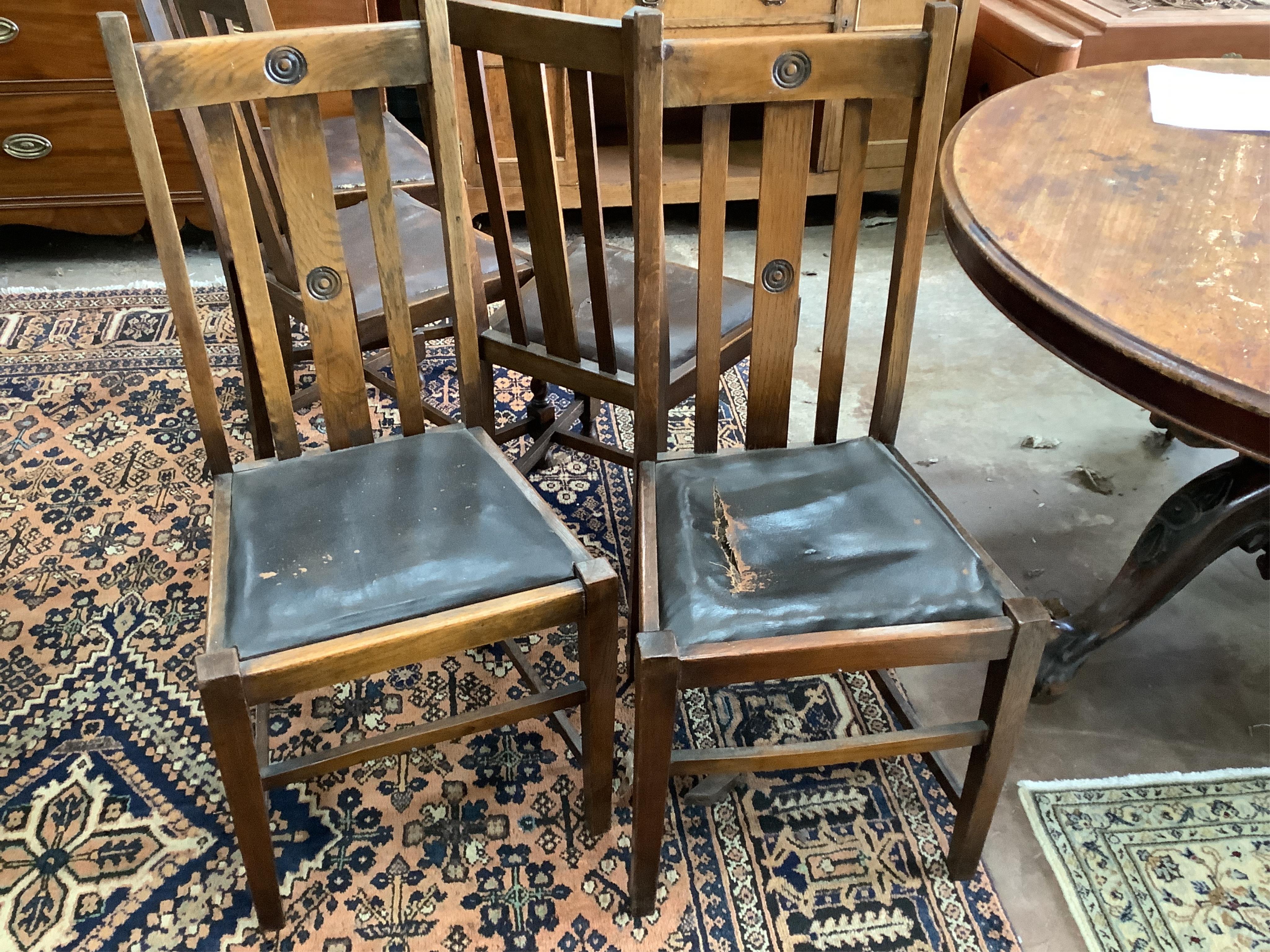 Eight 1920's oak dining chairs, two with arms